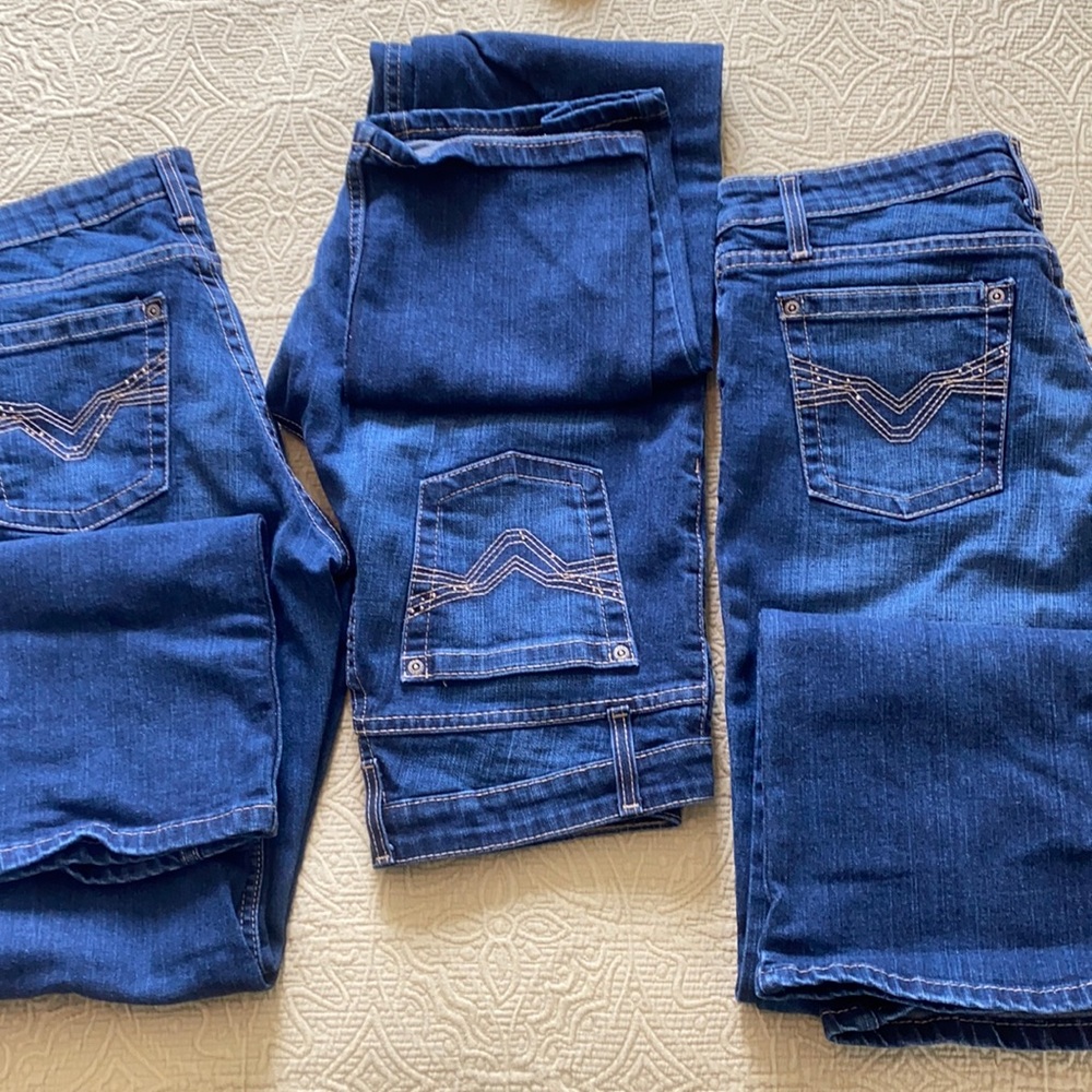 Three pair of Harley Davidson mid rise boot cut women’s jeans